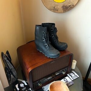 - The Sorel Joan Of Arctic Wedge Mid Boot is a chic city boot